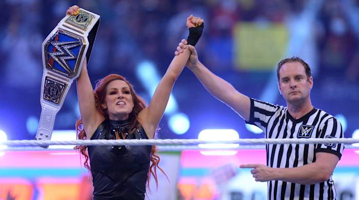 Becky Lynch (black attire) returns to WWE to challenge and defeat Bianca Belair (blue/white attire) in the WWE Smackdown Women's Championship match at SummerSlam 2021 at Allegiant Stadium.
